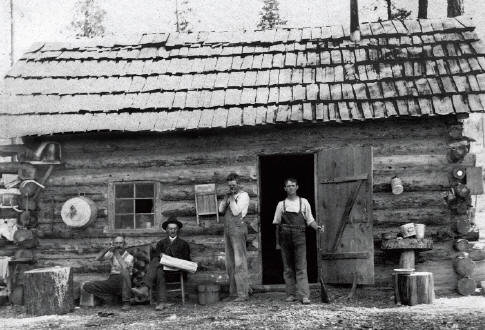 Cabin at Dallas Gem mine built during the summer 1907 for $35. Mine team with riffles and pistols. James Couch is second from the left. Photo courtesy of Collector’s Edge.